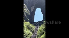 Chinese adventurer completes daring wingsuit flight through Tianmen Cave