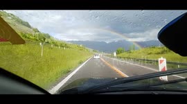 Intense rainbow filmed with dashcam phonecam  while driving around Lake Geneva Switzerland