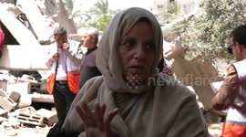 The Palestinian family of Nabhan react on the rubble of their house after it was hit by an Israeli air strike in in Beit Lahiya