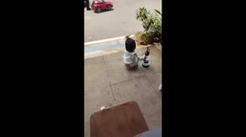 Cute toddler sits on mini chair phone stand in China