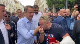 Greek PM Mitsotakis receives hand-kissing greetings from supporters ahead of national elections