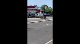 Comedic Instagram personality playfully races through the streets of Long Island, donning a microwave as a whimsical accessory