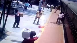 Shocking moment boy falls onto tracks while trying to catch moving train in India