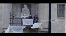 David Chic AKA 'Spider Man's comes down peacefully from the contraversial David Gill statue at BBC HQ, London