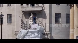 Controversial statue outside BBC attacked by masked protester before peacefully coming down