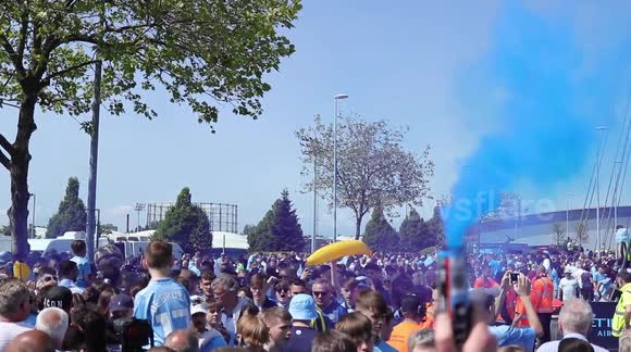 Blue smoke, chants and bananas: Man City fans welcome champion team bus home