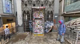 ATM covered in thousands of stickers at historical viewing platform in Lisbon, Portugal