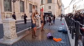 Topless activists pour mud on themselves outside Italian senate evoking deadly flooding