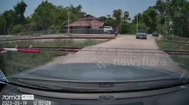 Oncoming train nearly crashes into bungling driver who ignored level-crossing warning
