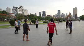 Locals play ball games as sun goes down in Phnom Penh, Cambodia