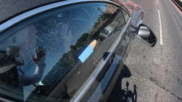 TV producer Jimmy Mulville sticks middle finger up after being caught using phone by cycling vigilante