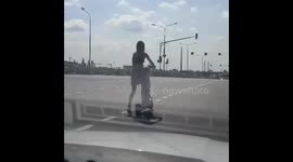 Woman and child embark on a dangerous scooter ride!