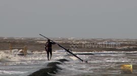 Windsurfer completely unphased by huge Storm Gertrude waves