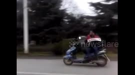 Man shows off his diving skill to sit on one side on motorcycle