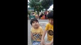 Kids playing in the market place in Liberty market playing with cycle