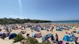 Packed Cornish beach as brits have half term fun in the sun at Treyarnon Bay