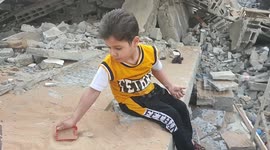 Palestinian children stand amid the rubble of their destroyed family home following Israeli strikes on the town of Beit Lahiya in the northern Gaza Strip