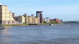 A Black And White Uber Boat By Thames Clipper Approaches Canary Wharf Pier To Temporarily Moor And Let Commuters Off