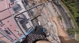 VERTIGO-INDUCING video footage shows the moment one super fit thrill-seeker decided to swap the gym for a 328-foot crane to practice his chin ups without any safety equipment.