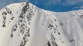 Skier triggers avalanche while cruising down snowy mountain in Alaska