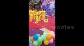 Sleepy toddler steals the show at Children's Day performance