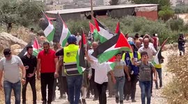 Palestinians argue with Israeli security forces during a protest in West Bank over outposts