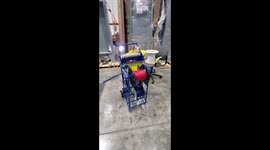 Workman makes funny dragon out of work equipment