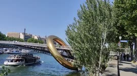 Inflatable Golden Ring installed on a bridge of Paris.