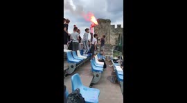 Trogir football hooligan trips over grand stand seat as he attempts to climb over them.