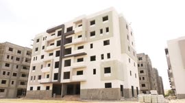 Egyptian workers work in the final stages of the Dar Misr 1 (al-Zahra city) housing project in the center of Gaza strip.