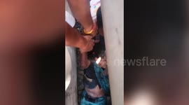 Watch as woman is pulled alive from train tracks in India's Madhya Pradesh.