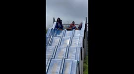 Woman Struggles to Go Down Slide