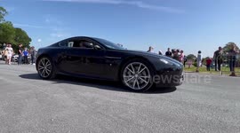 A nice Aston Martin vantage giving it some at a car meet.