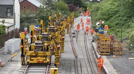 Pen lem machines carrying railway tracks(Timelapse) into place at Newtown Powys station.