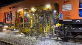 A railway tamper machine working hard at Newtown Powys.