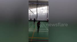 Volleyball player misses ball and drags over net