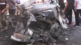 Palestinians inspect a car which reportedly said that sraeli troops blew it up in the village of Kafr Dan in Jenin, in the West Bank