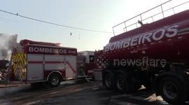 Firefighters put out a fire in the community of Osasco in Sao Paulo, Brazil