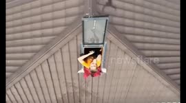 Drone drops water bottles to Kherson resident stranded in flooding