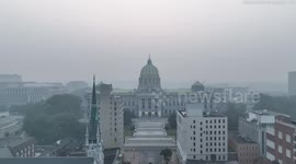 Drone footage shows Harrisburg, PA skyline obscured by a smoky haze