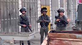 Israeli forces gather at a scene where a Palestinian woman detained reportedly accused of attempting to carry out a stabbing attack, in the town of Hawara, south of Nablus, in the West Bank
