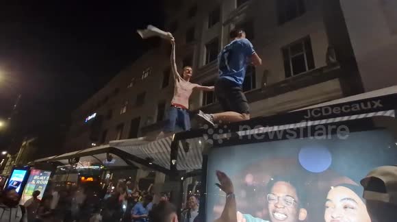 Triumphant Man City fans celebrate on top of bus stop after Champions League triumph