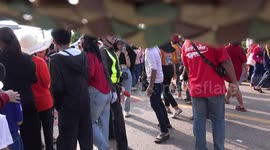 A dancing policeman joins the rocket festival parade and party in a village in Northern Thailand.