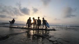Palestinians spend their time on the beach during a hot day in Deir El Balah central Gaza Strip