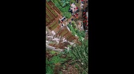 Devastating landslide strikes South Bogor District, leaving railway line hanging and villagers trapped in debris