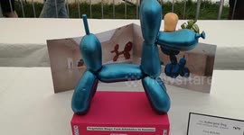 At the vegetable Sculpture show at the Lambeth Country Show someone recreates a Famouse artwork by Jeff Koons but the artwork is created out of Aubergines