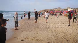 Palestinian youths practice free jumping on the seashore of the city of Deir al-Balah in the central Gaza Strip