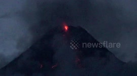 Newsflare Edit - Lava flows out of Mayon Volcano's crater as slow eruption continues