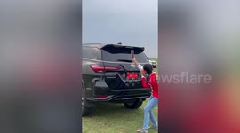 Swarms of bees gather on roof of family's car