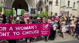 Pro-abortion protesters gather outside the Royal Courts of Justice.